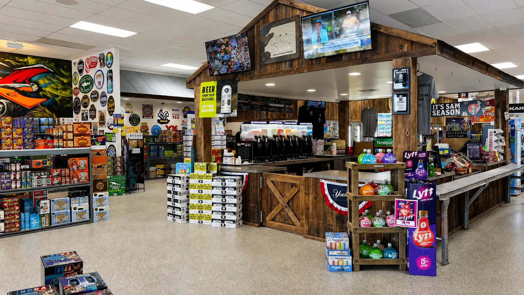 Interior of Brewie Louie's Beer Stop — barn-wood checkout counter, slushie machines, and walls of craft beer